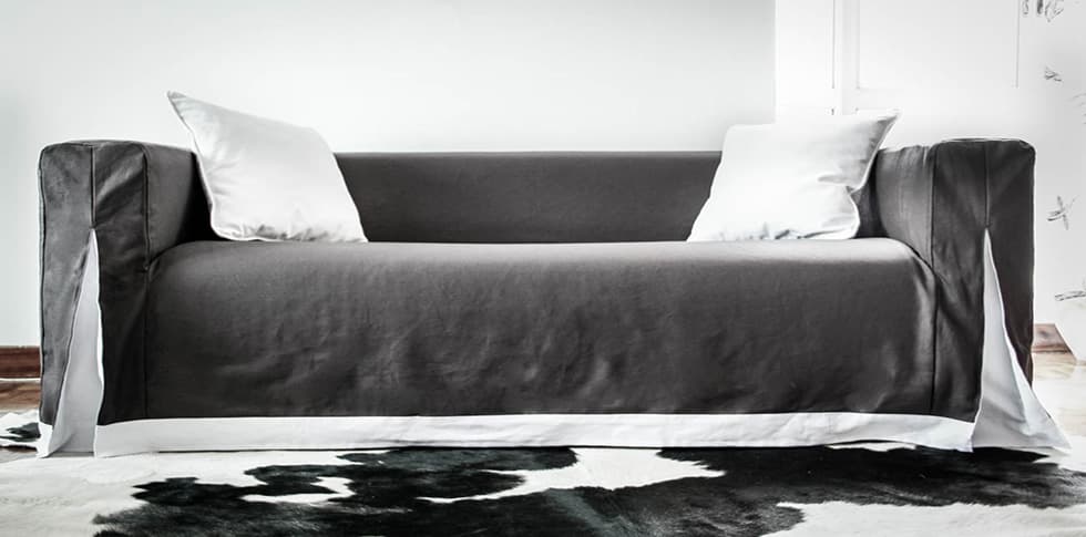 Long skirted Klippan sofa cover with unique pleats and contrast skirting by Comfort Works